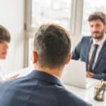 Professional business meeting with colleagues discussing strategy.